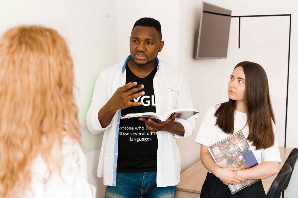 Tres personas usando expresiones comunes en inglés en una conversación.